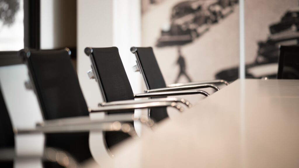 Empty chairs sitting beside a meeting table