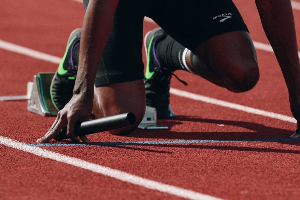 A track and field runner preparing to race at the starting line