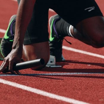 A track and field runner preparing to race at the starting line